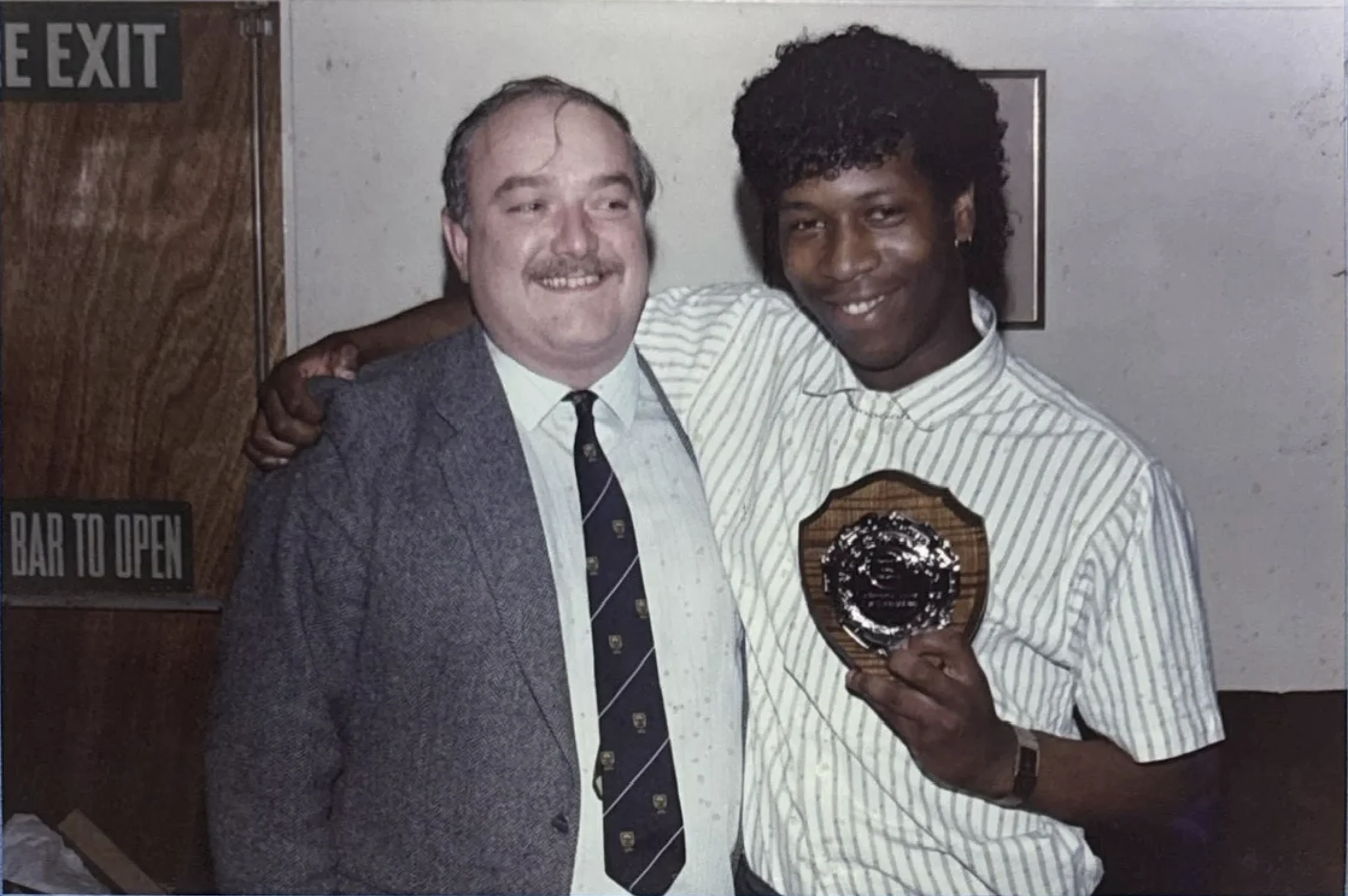Mark Rosegreen receives an award, pictured with a club official