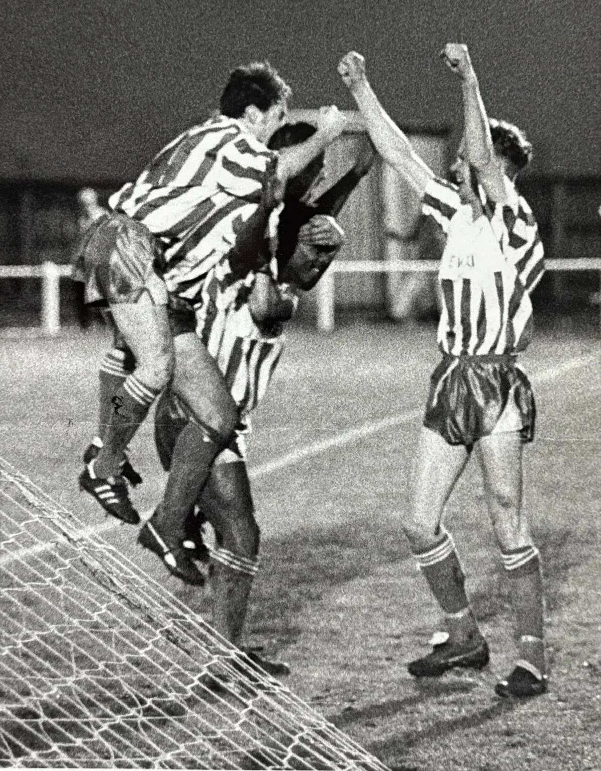Nuneaton Borough players celebrate a goal, arms raised